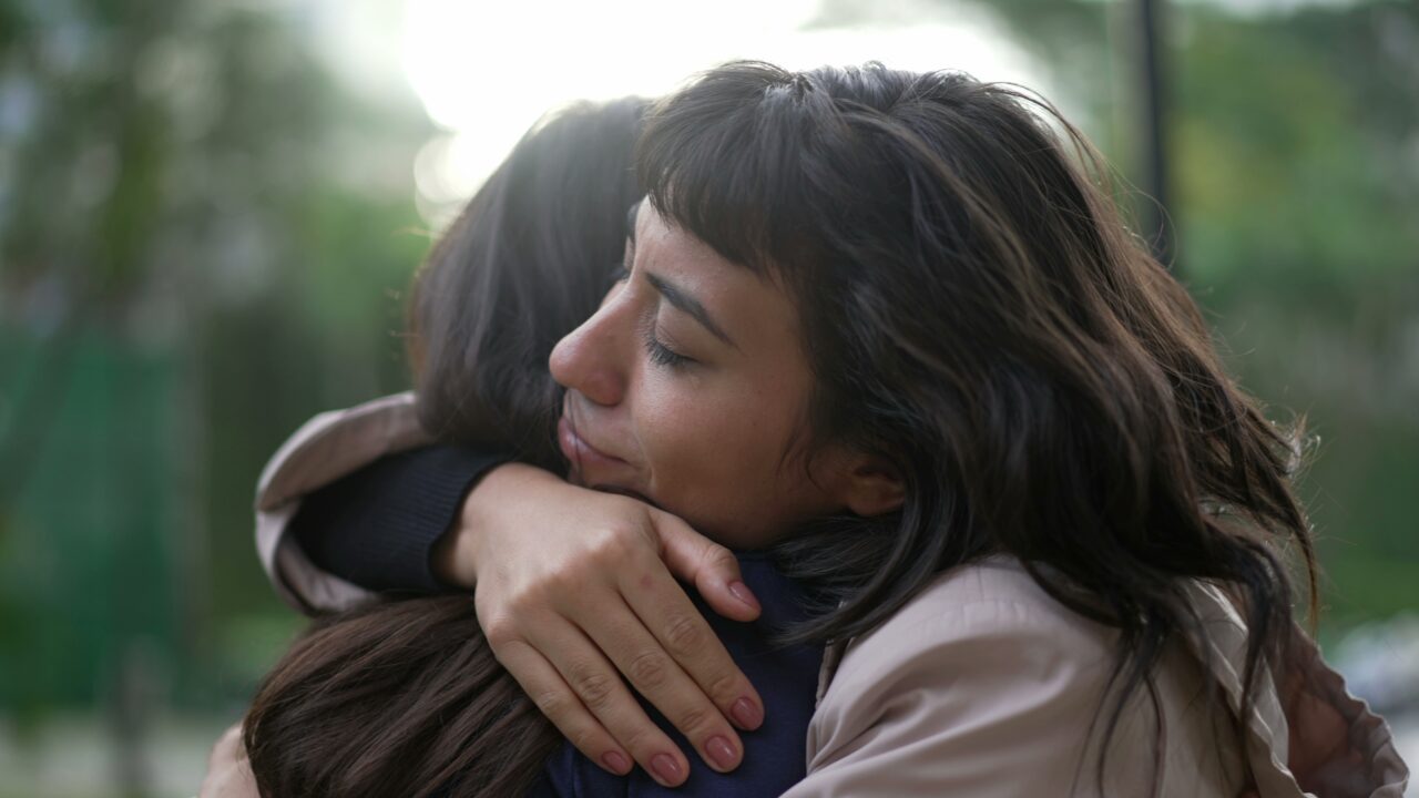 Sympathetic woman hugging friend.