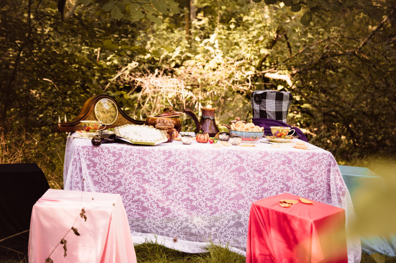 A table is set with a mad hatter tea party.