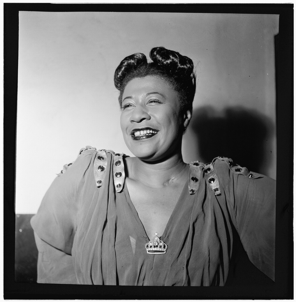 Ella Fitzgerald looking radiant with a crown brooch and gorgeous smile.