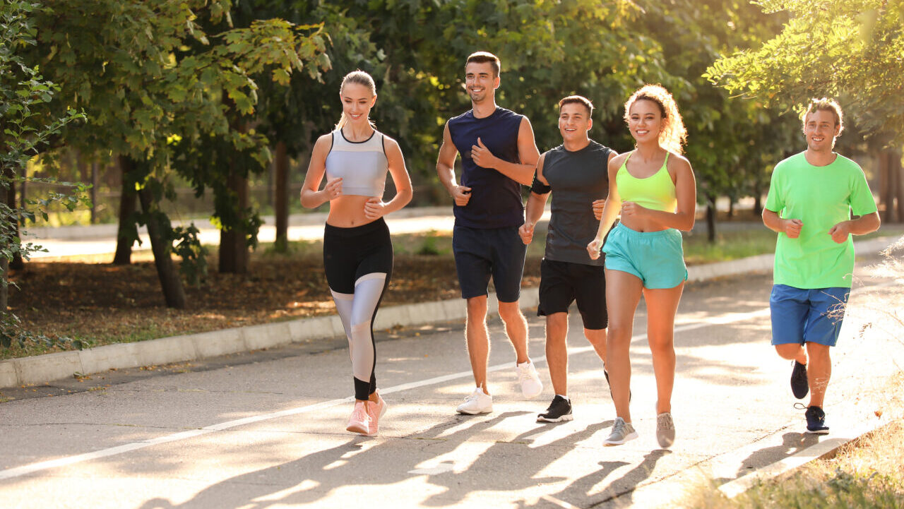 Group of young people running outdoors.