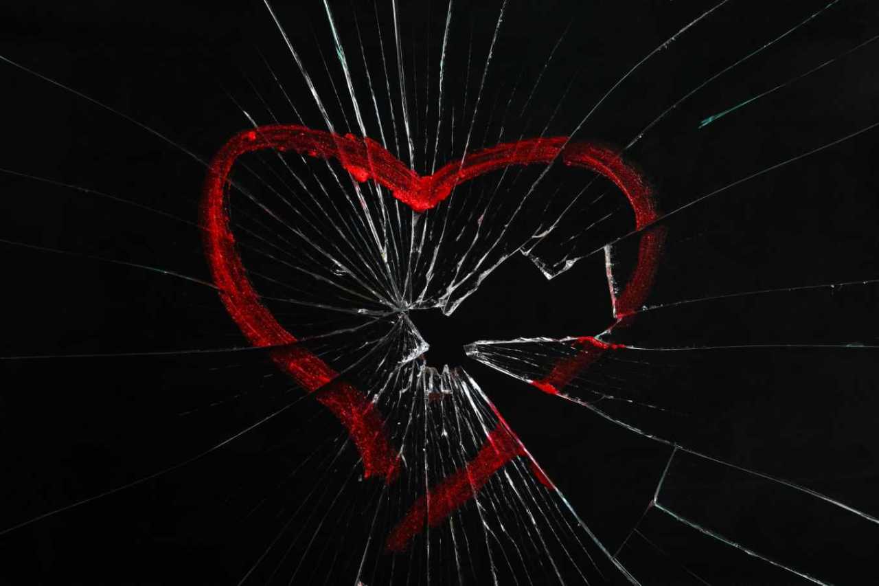 read heart drawn on broken shattered glass.