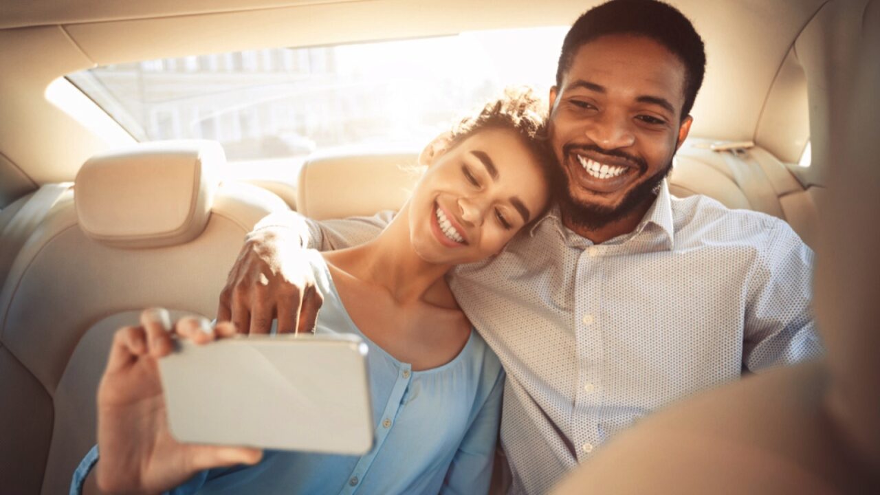 Happy couples in back seat of car