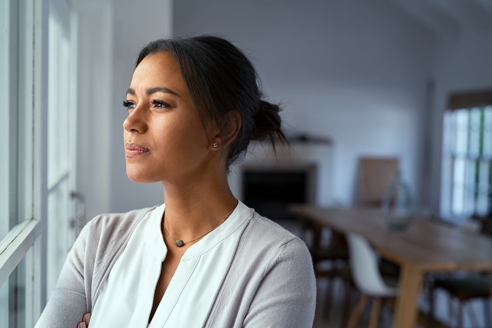 Mature,African,Woman,Looking,Outside,Window,With,Uncertainty.,Thoughtful,Mid