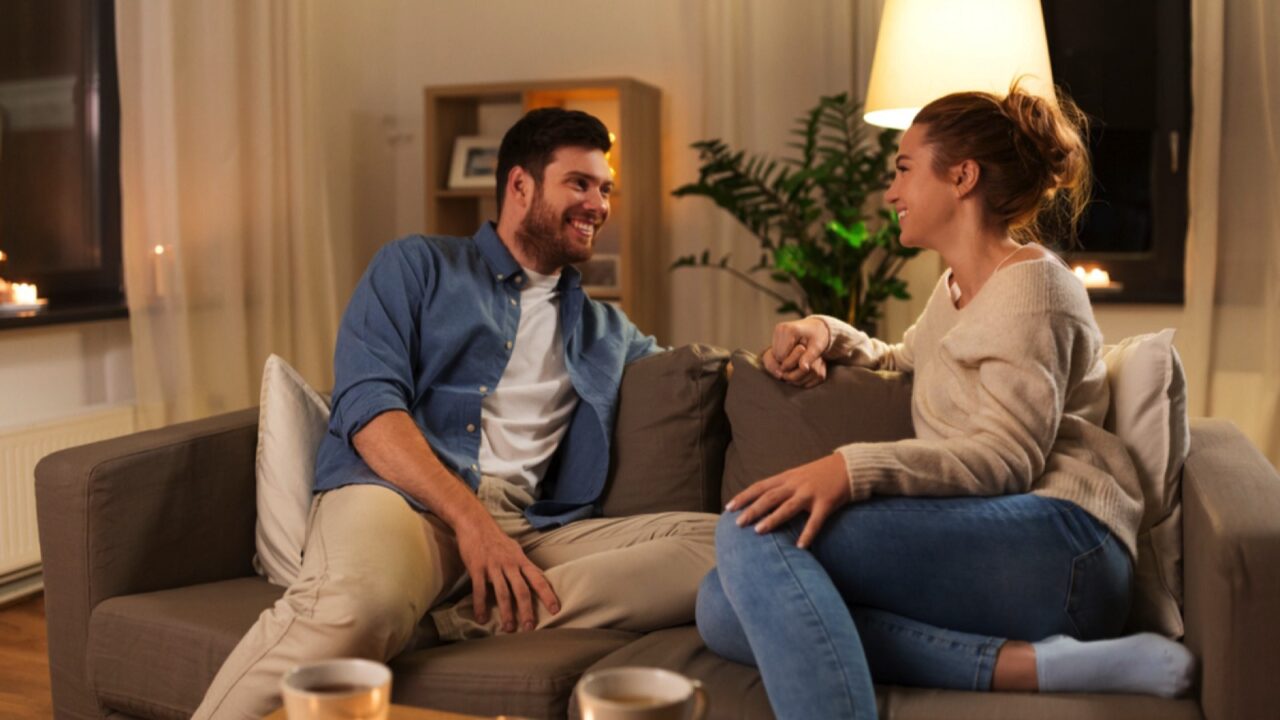 Happy couple talking at home in evening