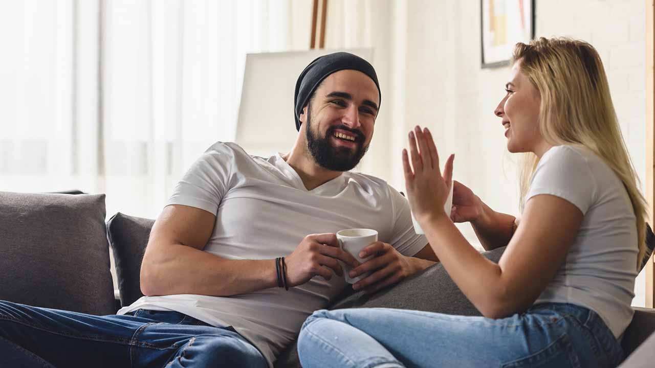 couple having a candid discussion on the couch.